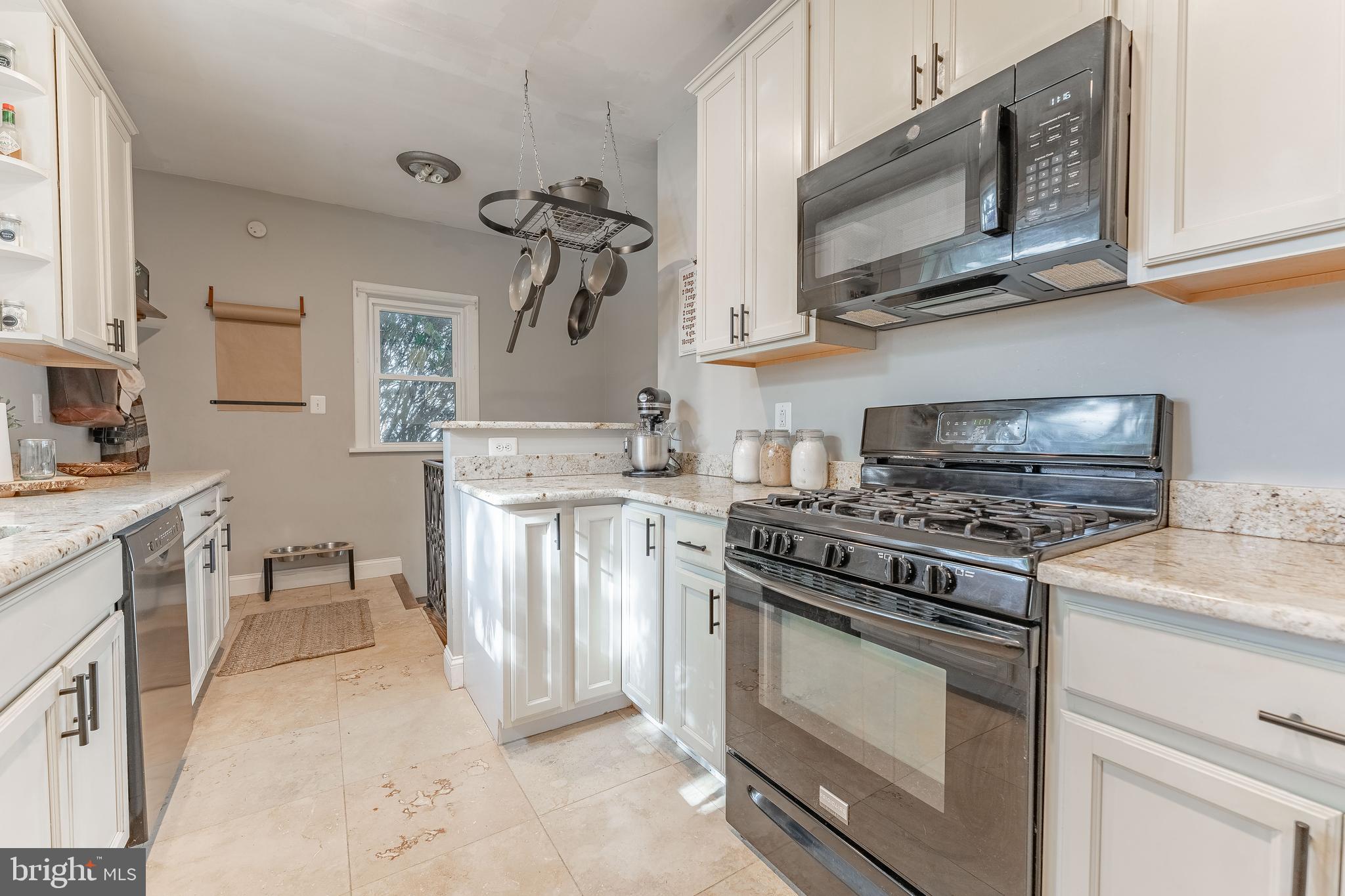 864 North Avenue Springfield, PA 19064 - Photo 20 of 33 a kitchen with stainless steel appliances granite countertop a stove a sink and a microwave