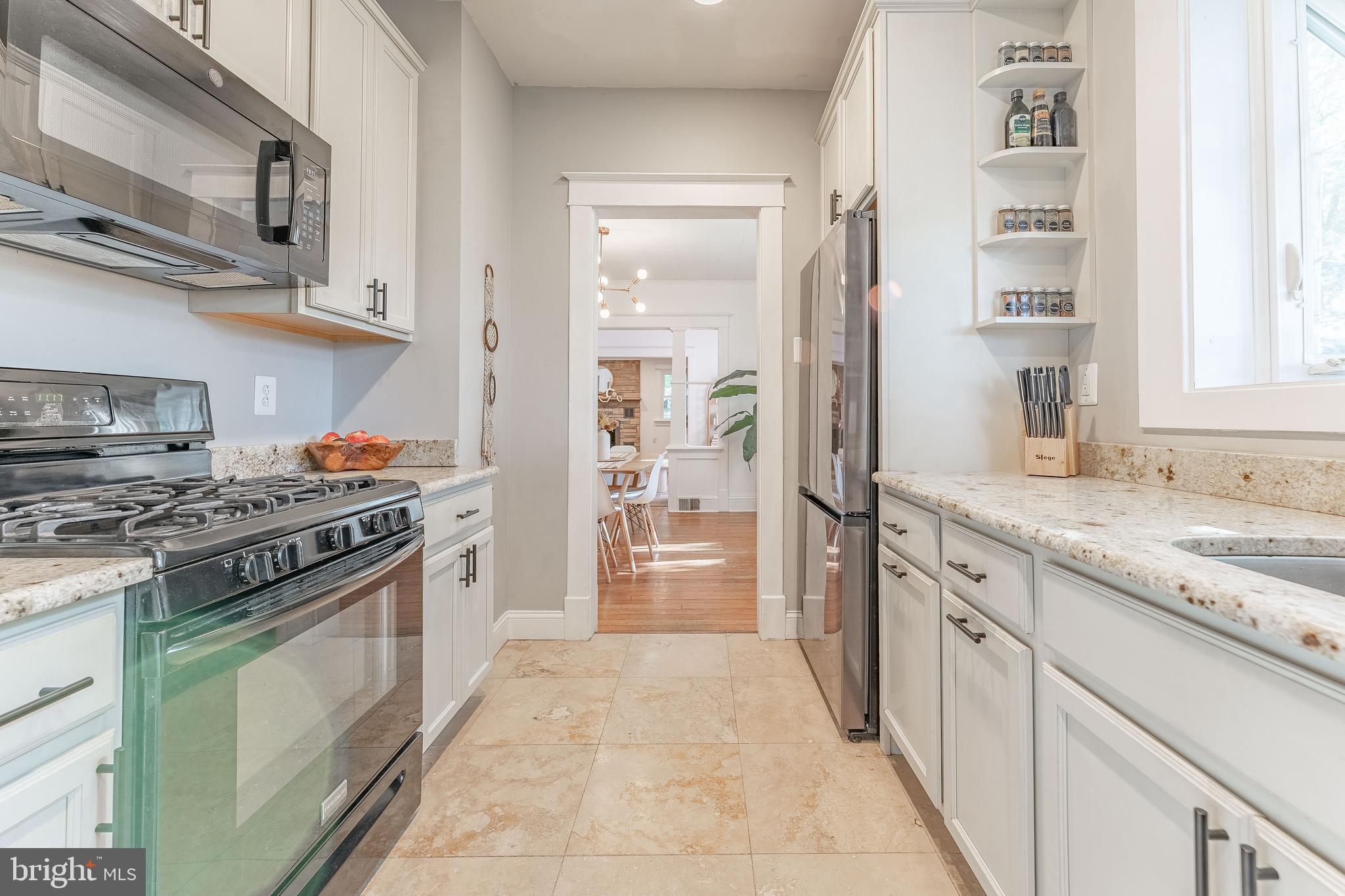 864 North Avenue Springfield, PA 19064 - Photo 21 of 33 a kitchen with stainless steel appliances granite countertop a stove and a refrigerator