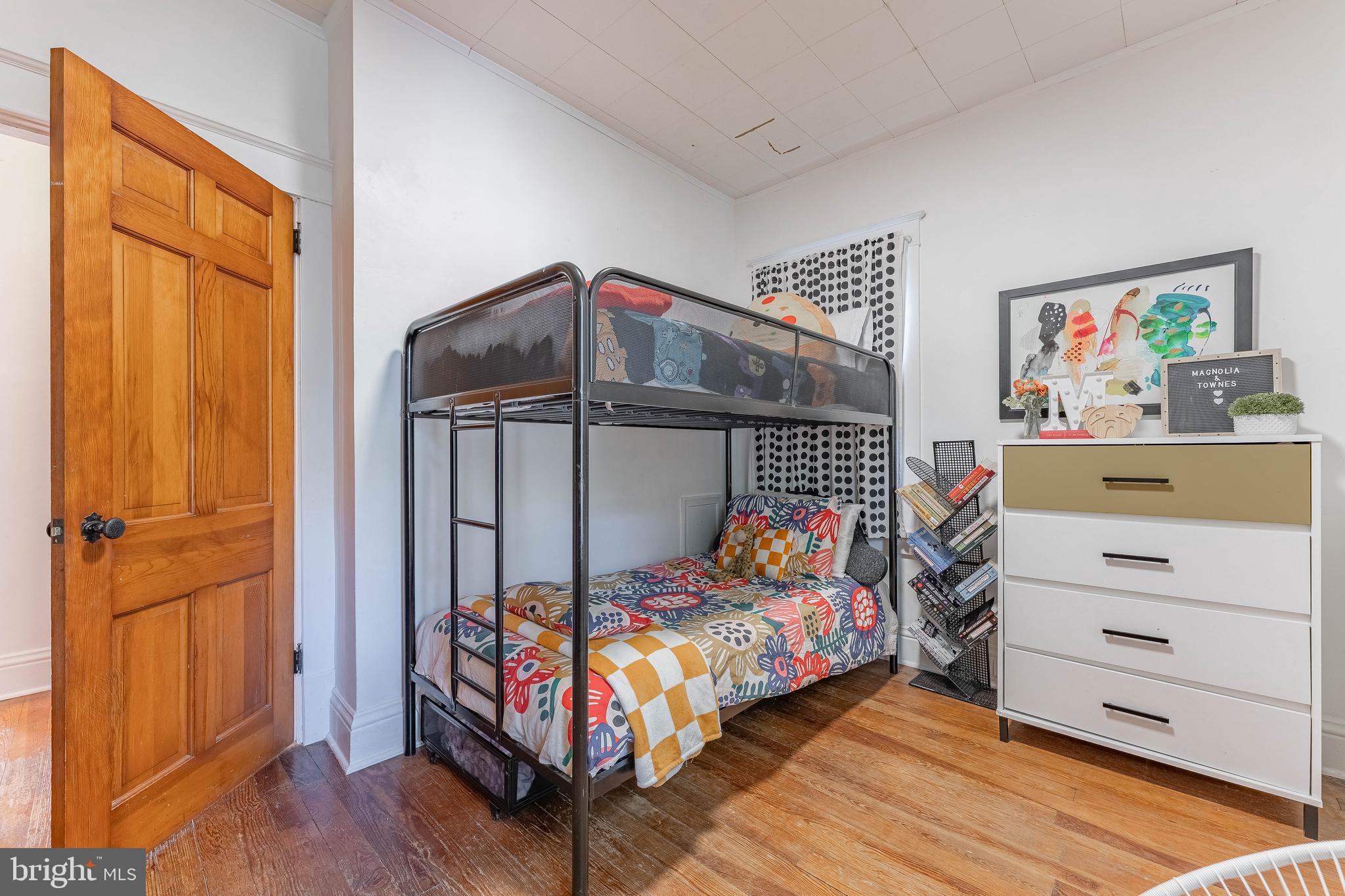 864 North Avenue Springfield, PA 19064 - Photo 29 of 33 a bedroom with a bed and wooden floor