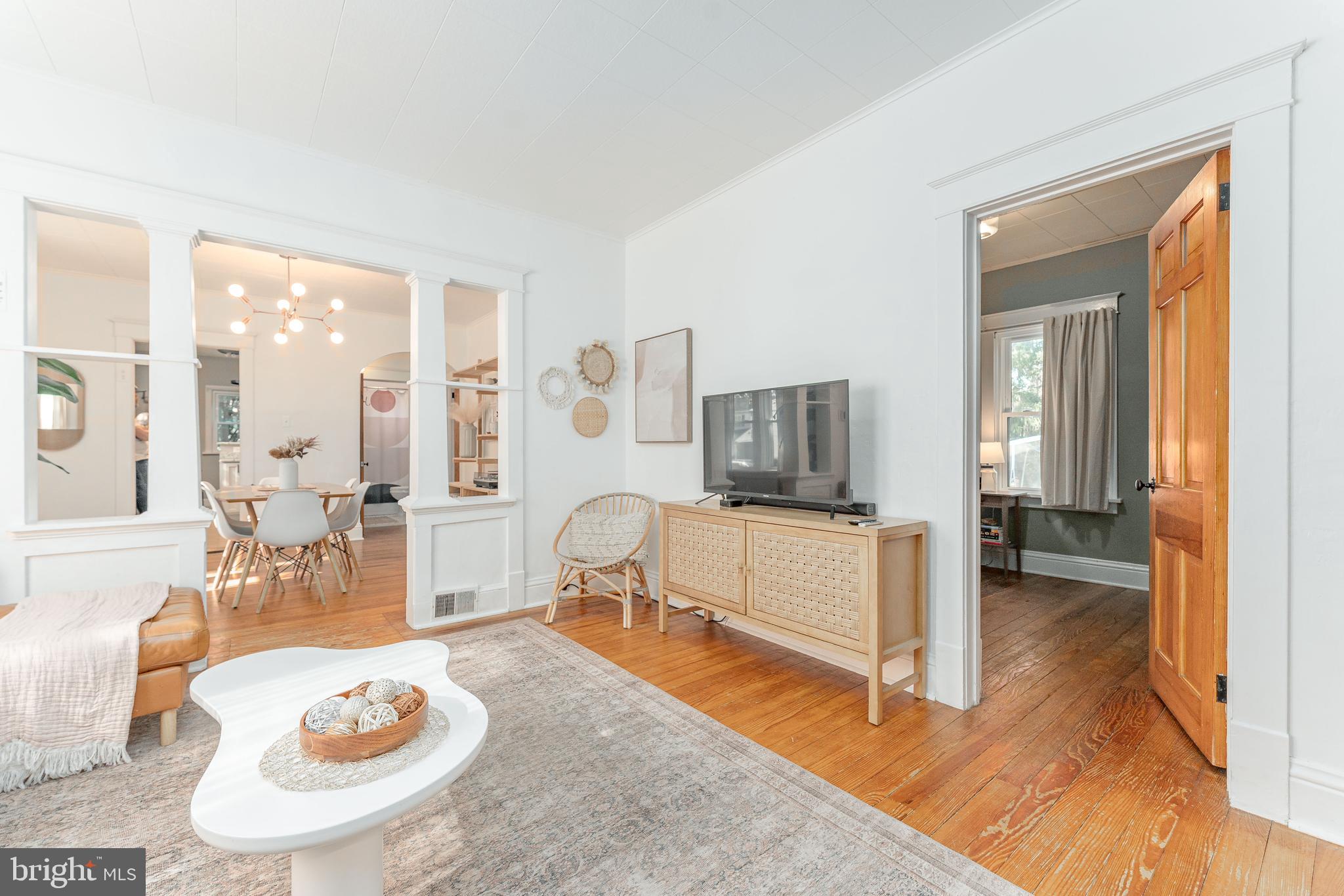 864 North Avenue Springfield, PA 19064 - Photo 10 of 33 a living room with furniture a flat screen tv and a table