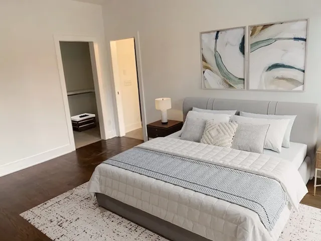 a bedroom with a bed and a mirror