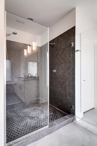 a bathroom with a glass shower door