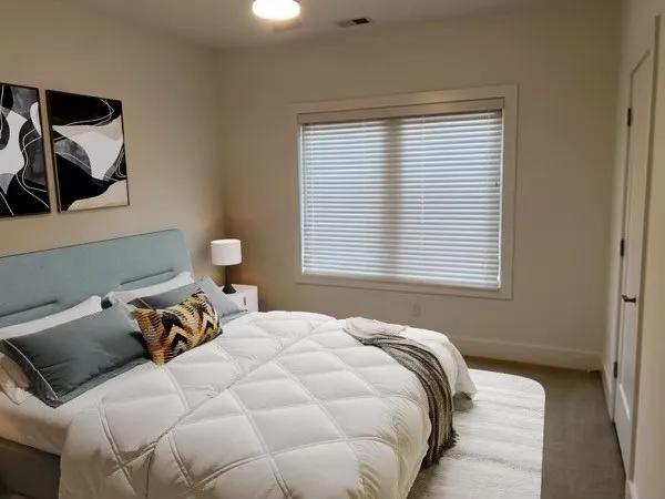 a bedroom with a bed and window