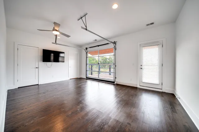 a view of a livingroom with wooden floor and window