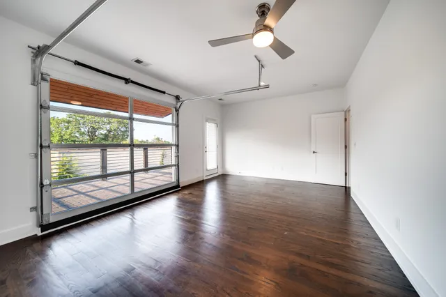 a view of room with wooden floor and fan