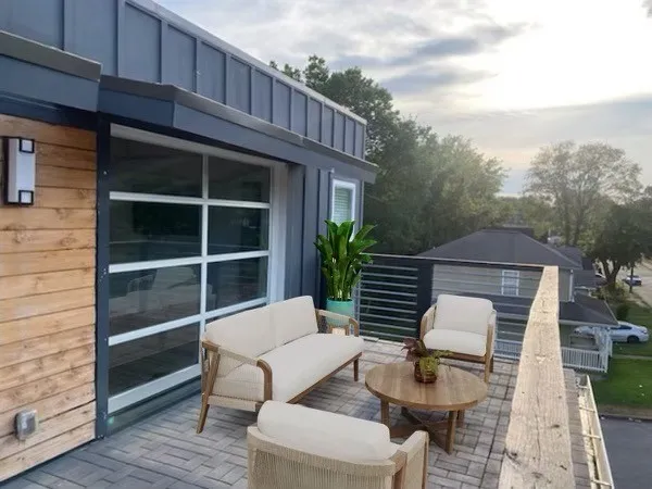 a view of a balcony with wooden floor and fence