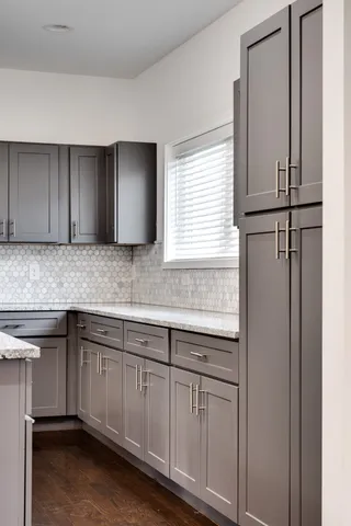 a kitchen with stainless steel appliances granite countertop a sink and a refrigerator