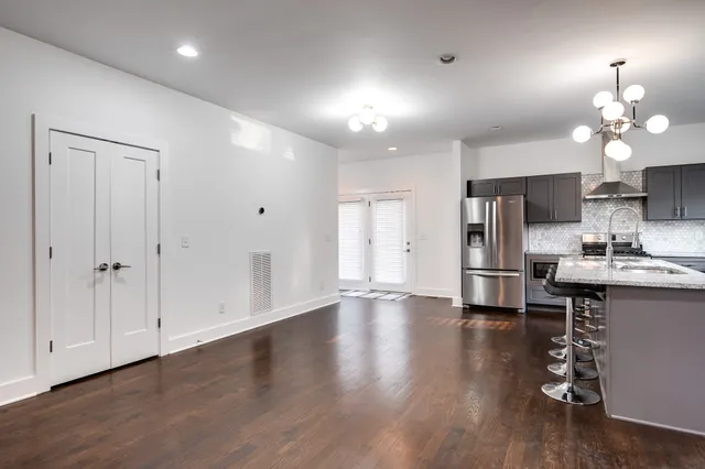 a view of a kitchen with a sink a refrigerator and a stove