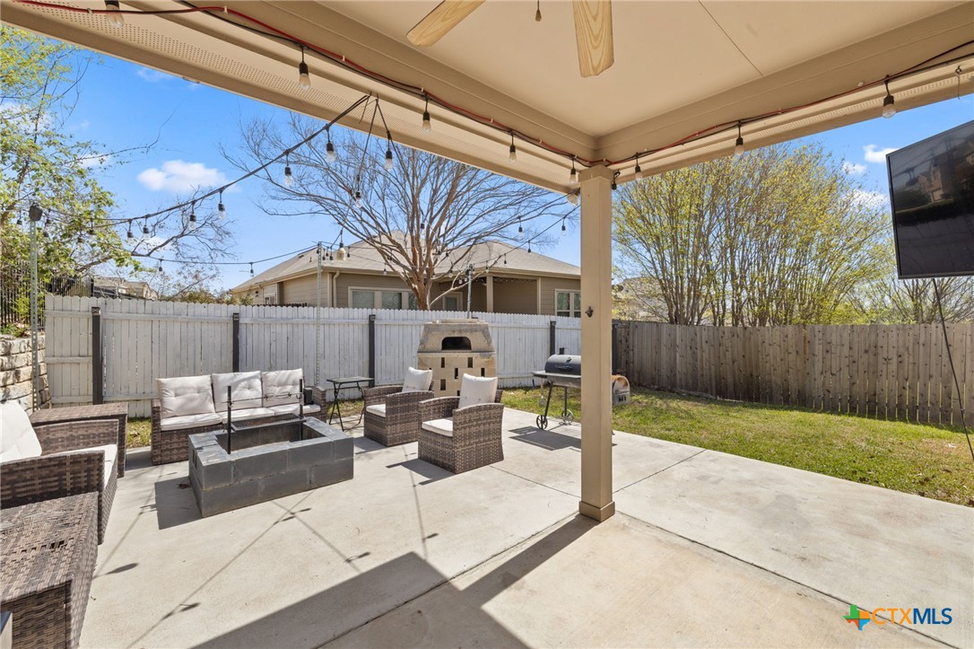 10113 Copper Ridge Cove Austin, TX 78747 - Photo 31 of 32 a outdoor living space with patio furniture and a potted plant