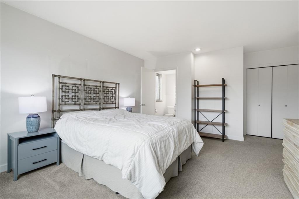 128 North Craig Street, Unit 814 Pittsburgh, PA 15213 - Photo 17 of 34 a spacious bedroom with a bed and a cabinets