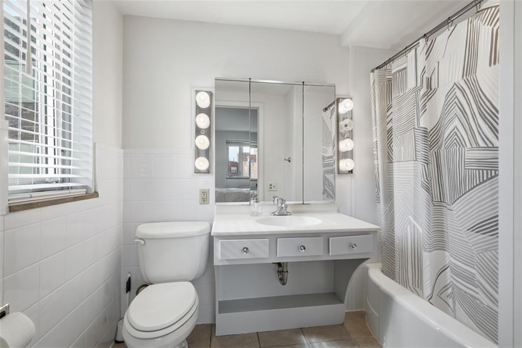 128 North Craig Street, Unit 814 Pittsburgh, PA 15213 - Photo 19 of 34 a bathroom with a sink toilet vanity and shower