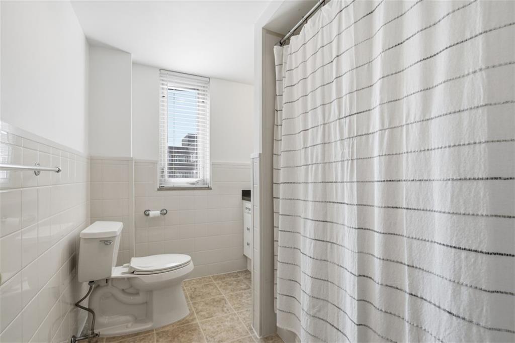 128 North Craig Street, Unit 814 Pittsburgh, PA 15213 - Photo 23 of 34 a white toilet sitting next to a shower curtain