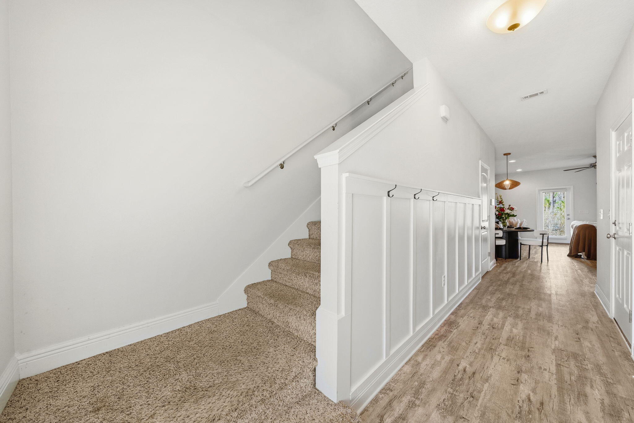 25 Crossing Lane, Unit C Santa Rosa Beach, FL 32459 - Photo 13 of 37 a view of a hallway with wooden floor and staircase