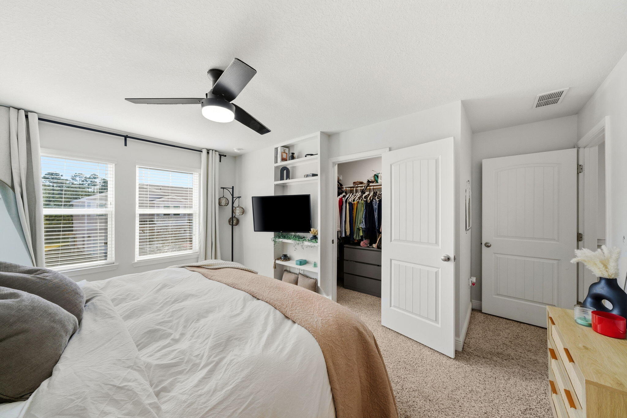 25 Crossing Lane, Unit C Santa Rosa Beach, FL 32459 - Photo 16 of 37 a bedroom with a bed and a flat tv screen on the dresser