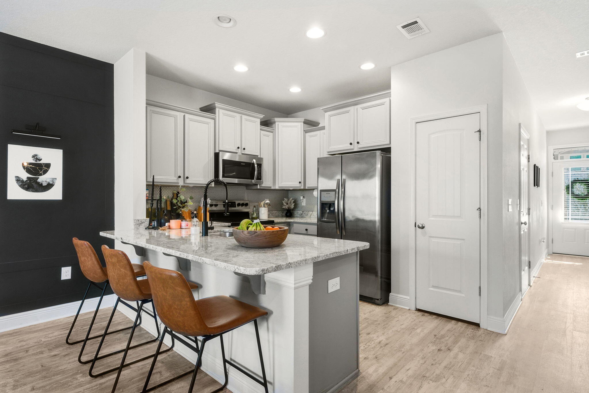 25 Crossing Lane, Unit C Santa Rosa Beach, FL 32459 - Photo 6 of 37 a kitchen with refrigerator and chairs