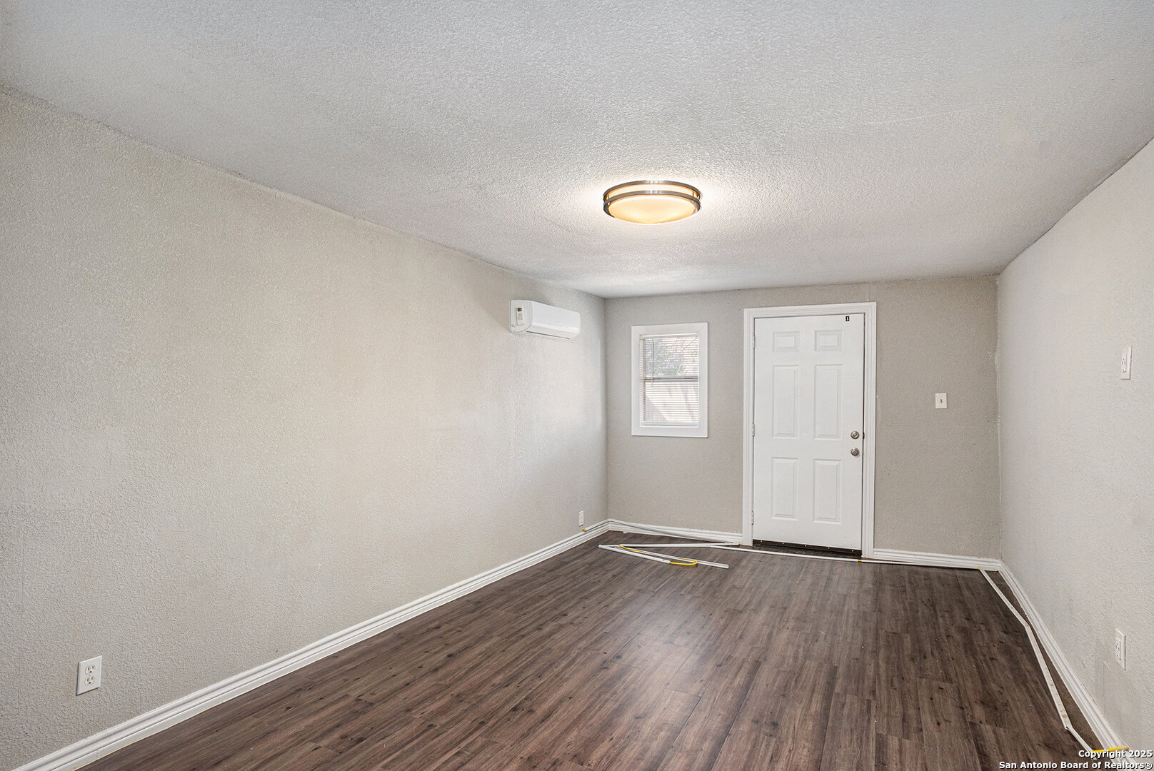 10023 Amber Field Drive San Antonio, TX 78245 - Photo 12 of 28 a view of a room with wooden floor and white walls