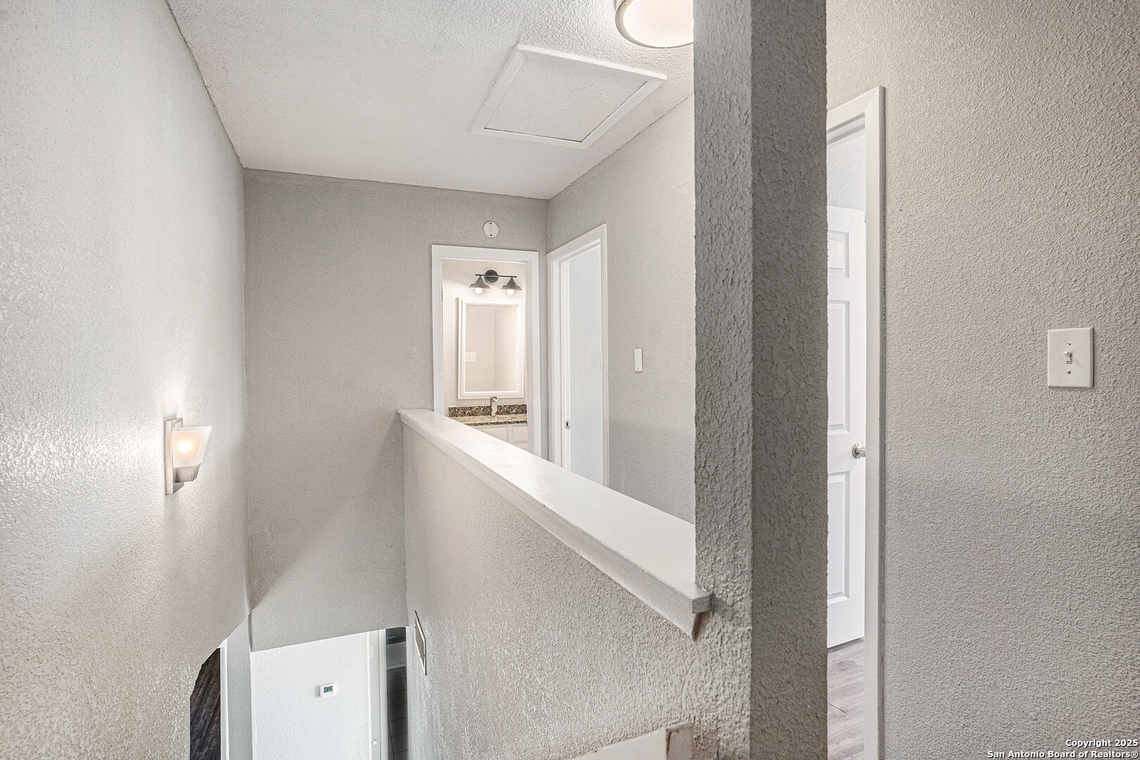 10023 Amber Field Drive San Antonio, TX 78245 - Photo 17 of 28 a view of hallway with bathroom and mirror