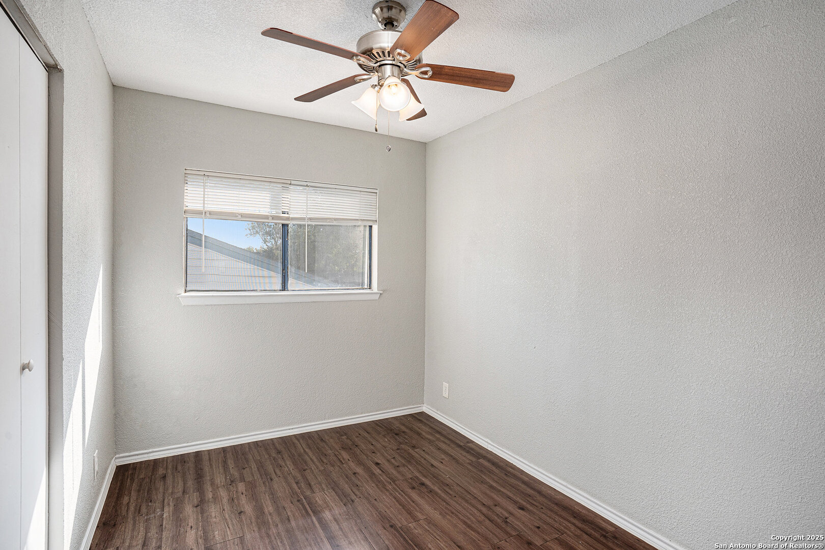 10023 Amber Field Drive San Antonio, TX 78245 - Photo 18 of 28 an empty room with a window and a fan