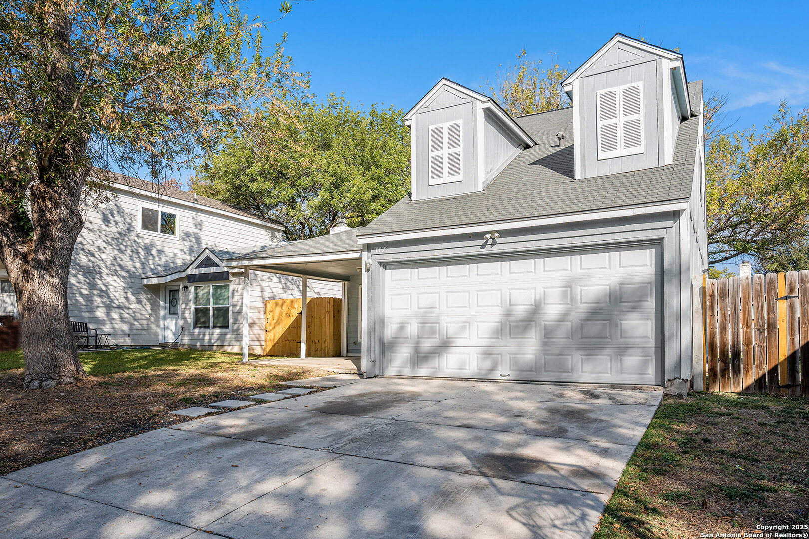 10023 Amber Field Drive San Antonio, TX 78245 - Photo 2 of 28 a front view of a house with a yard and garage