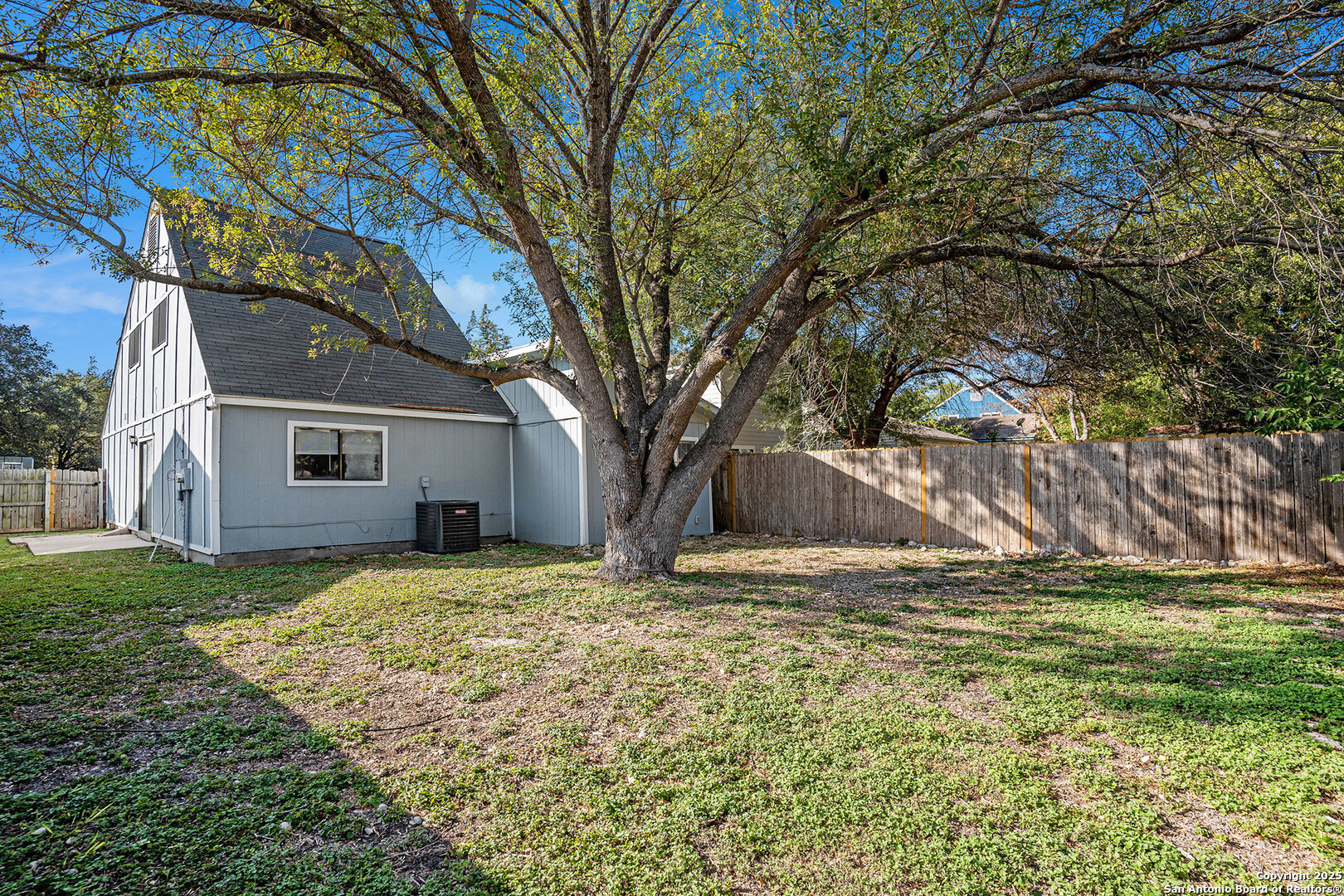 10023 Amber Field Drive San Antonio, TX 78245 - Photo 25 of 28 a view of a yard in front of a house with large trees