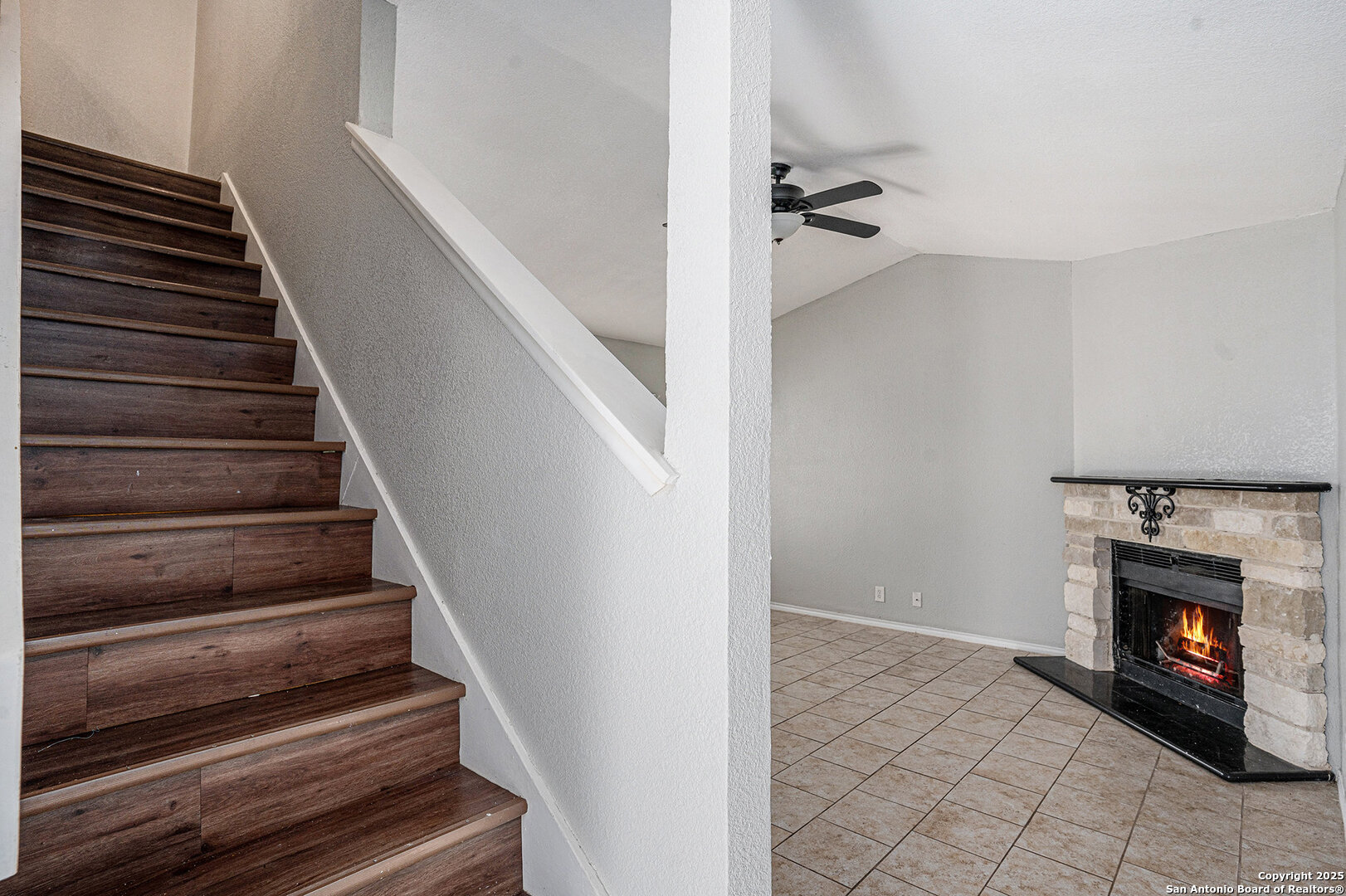 10023 Amber Field Drive San Antonio, TX 78245 - Photo 7 of 28 a view of an empty room with wooden floor and a fire place