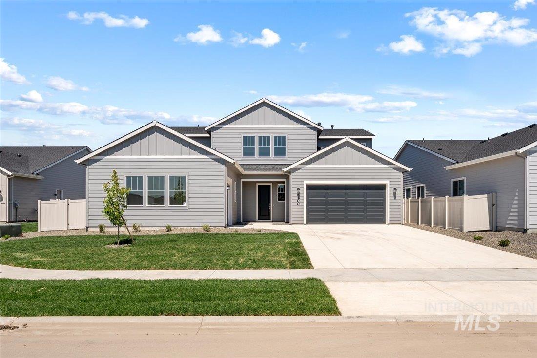 View of front of home featuring board and batten siding, concrete driveway, and a garage
