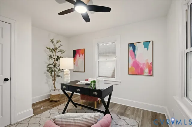 a workspace room with furniture and wooden floor