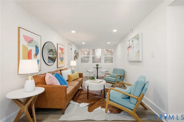 a living room with furniture and a wall painting