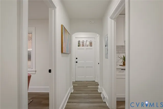 a view of a hallway with wooden floor and closet