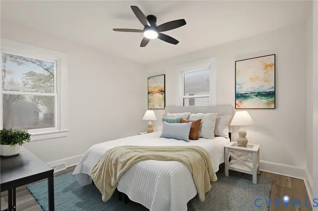 a bedroom with a bed and a potted plant