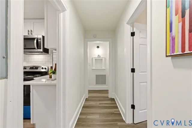 a kitchen with cabinets and a refrigerator