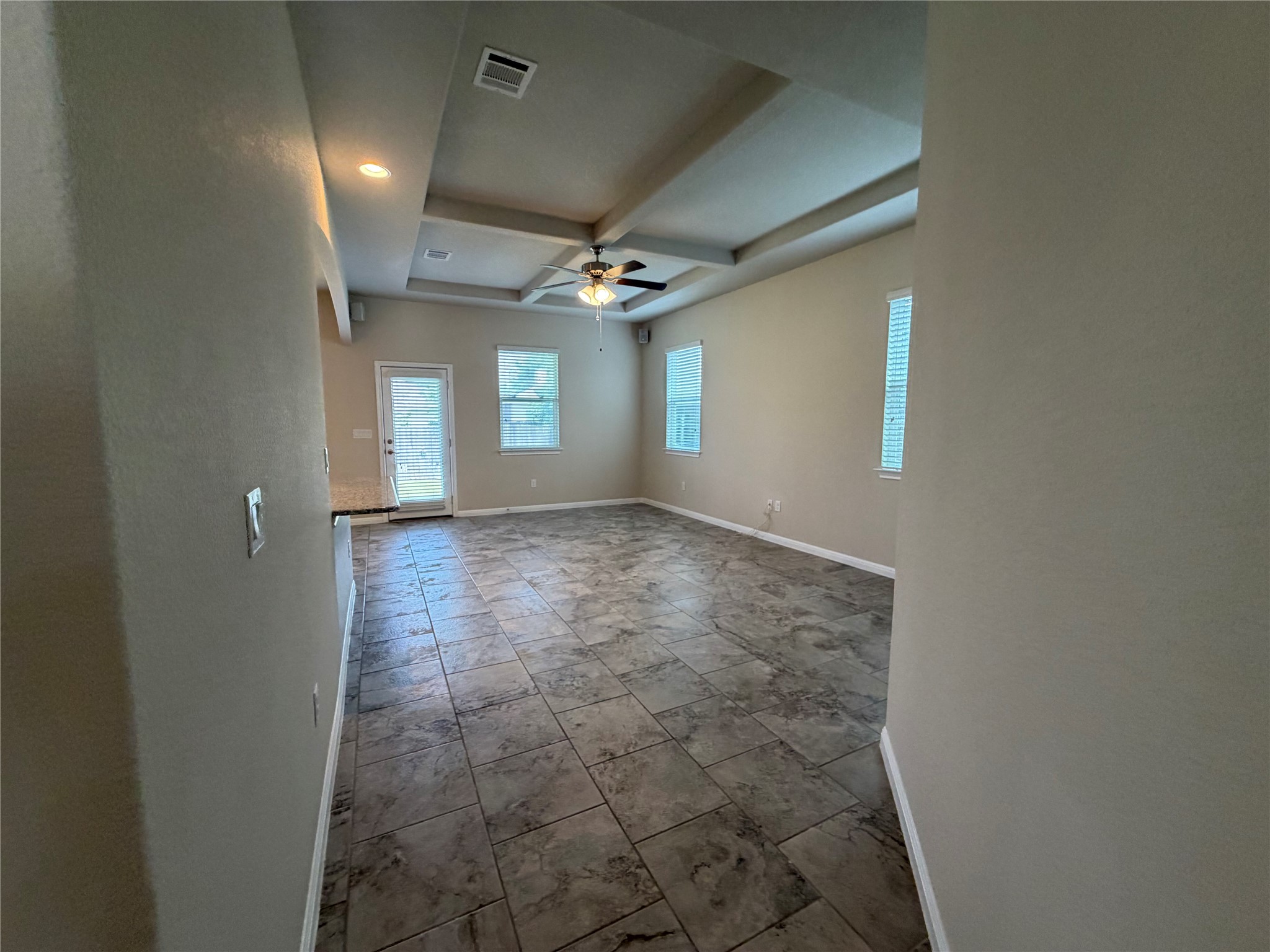 419 Gettysburg Loop Elgin, TX 78621 - Photo 14 of 21 A spacious living area with coffered ceilings and ample natural illumination.