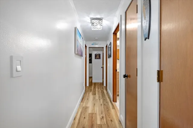 a view of a hallway with wooden floor