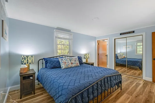 a bedroom with a large bed and a chandelier