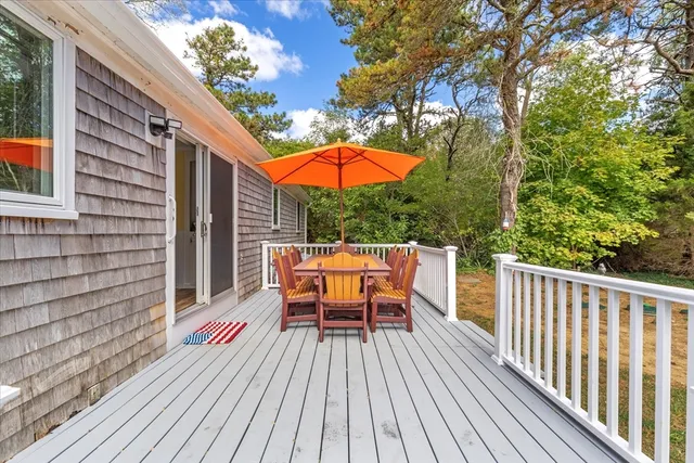a view of balcony with chairs and wooden fence