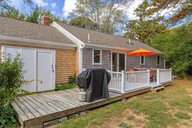 a view of backyard with deck and outdoor seating
