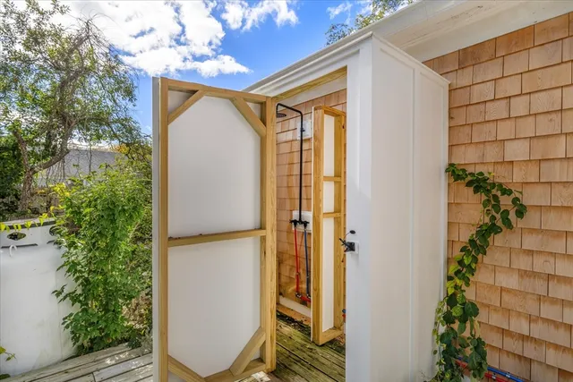 a bathroom with a shower and a mirror