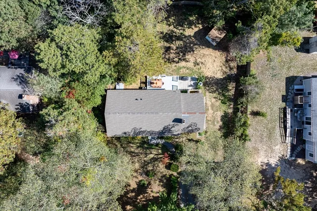 an aerial view of a house with a yard