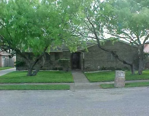 a front view of a house with a yard and a garage