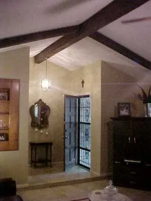 a hallway with dining table and a mirror
