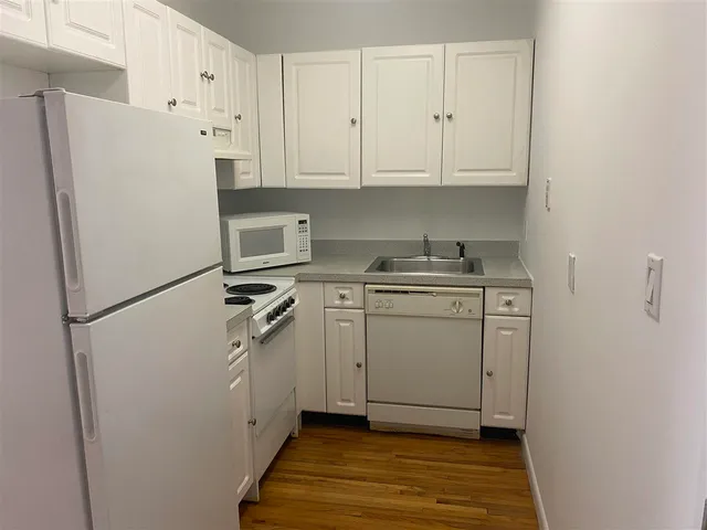 a utility room with cabinets washer and dryer