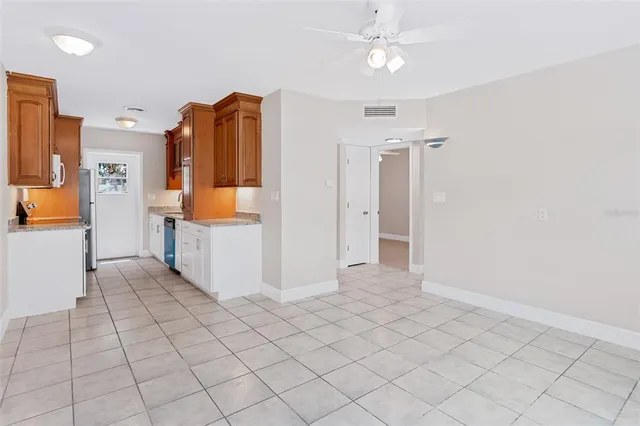 a view of kitchen with furniture and refrigerator
