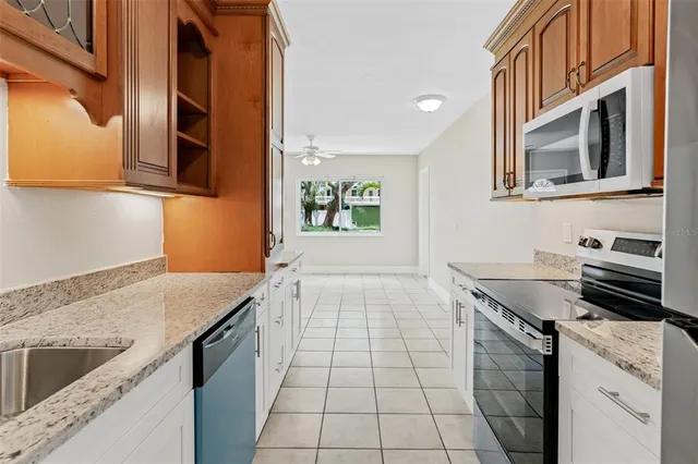 a kitchen with granite countertop a stove and a sink