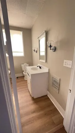 a view of a bathroom with bathtub shower sink and mirror