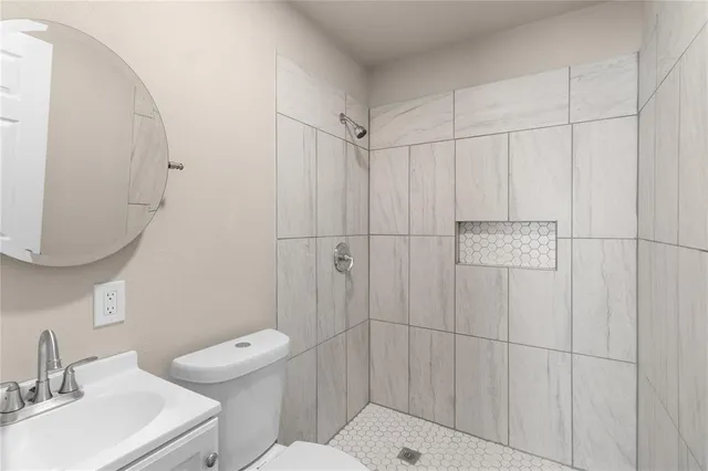 a bathroom with a sink toilet and shower