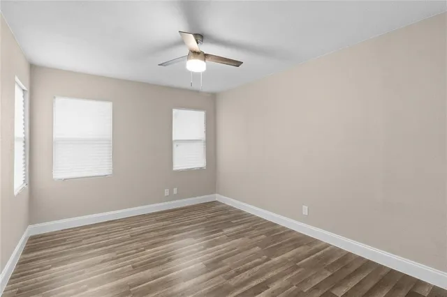 wooden floor in an empty room with a window