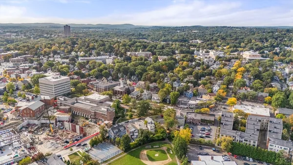 an aerial view of residential houses with city view