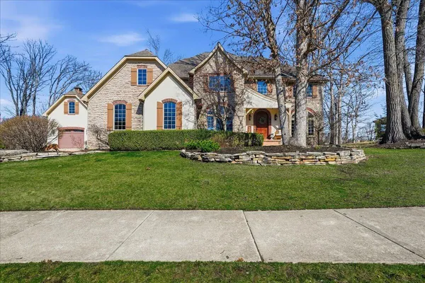a front view of a house with a yard and garage