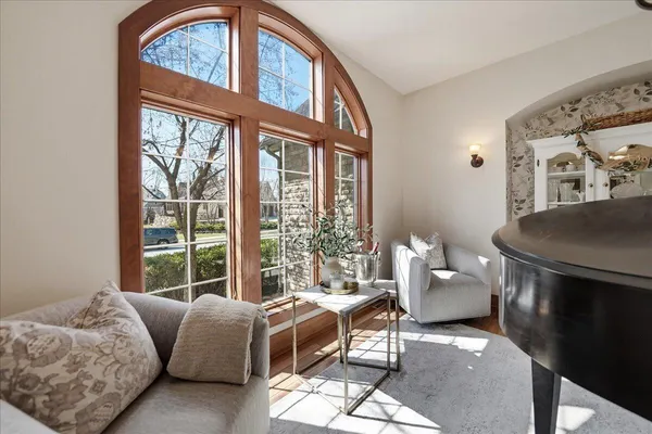 a living room with furniture a rug and a chandelier