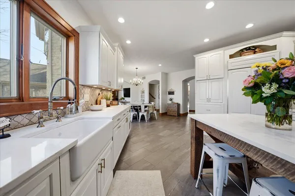 a view of a hallway with wooden floor and stairs